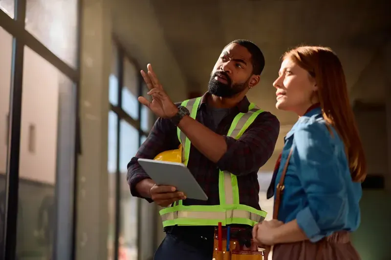 Workers using a tablet in a warehouse