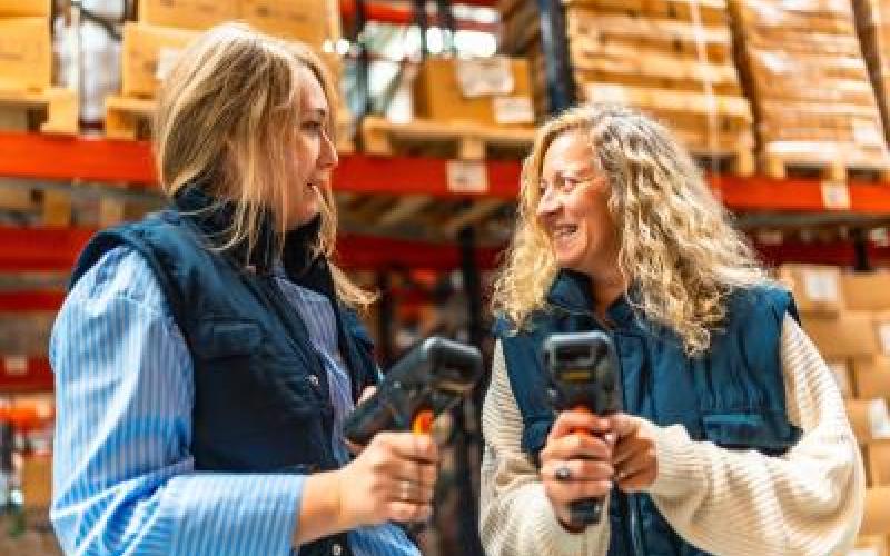 Two workers talking in a warehouse