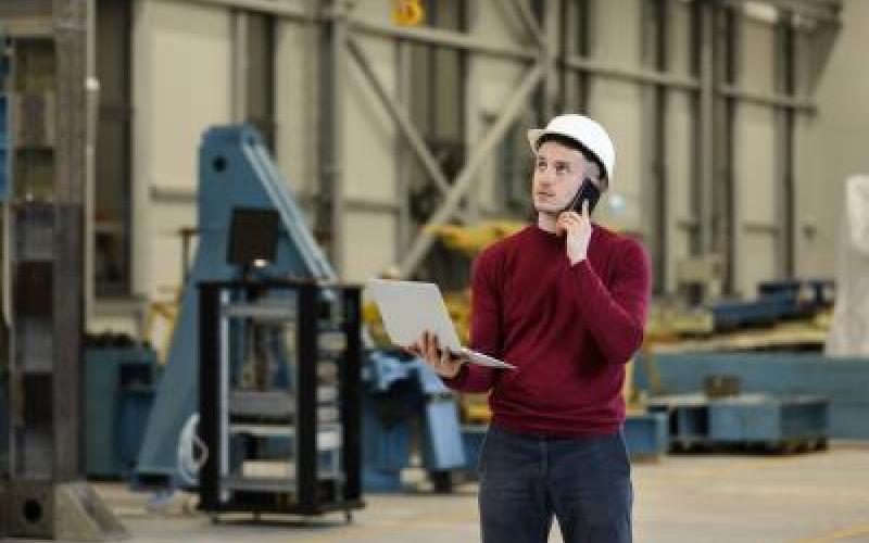 •	Male and female coworkers managing inventory in a manufacturing setting