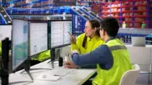Business managers tracking inventory on a computer