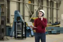 •	Male and female coworkers managing inventory in a manufacturing setting